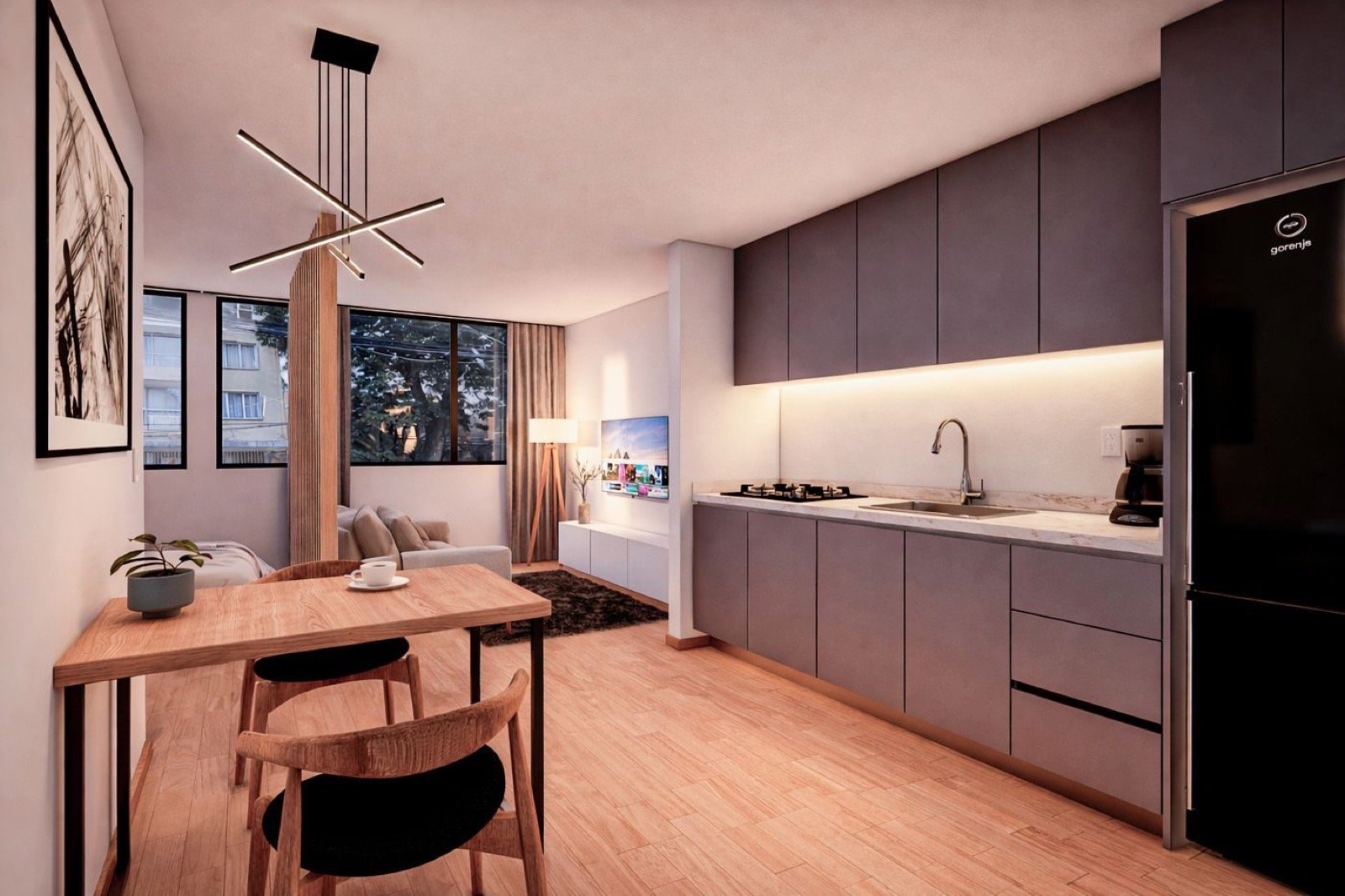 Cocina lineal con gabinetes grafito, comedor de madera y sala con ventanales